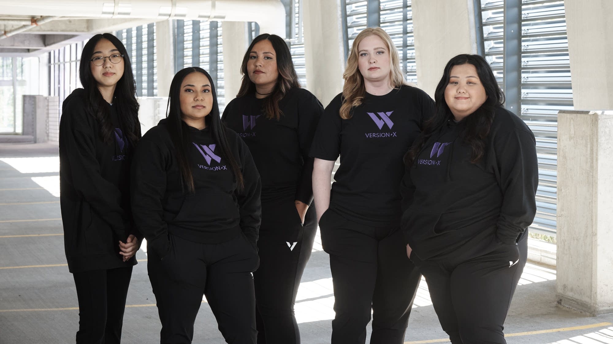 Five women stand for a portrait.
