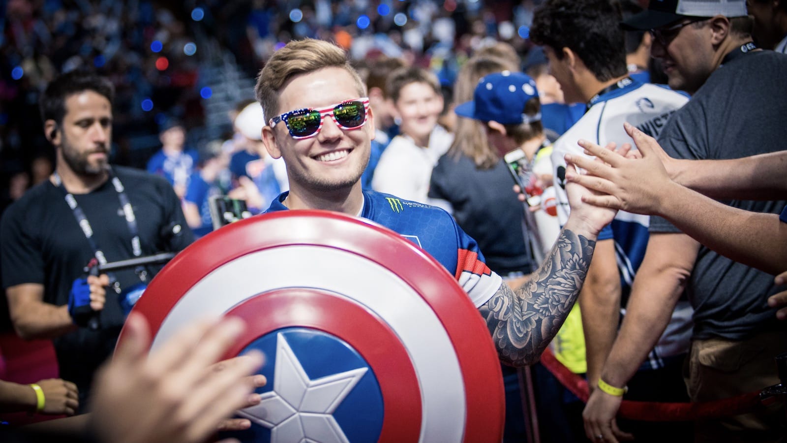 CS:GO player Nitr0 holding a Captain America shield and sunglasses in the middle of a crowd
