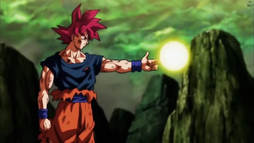 Zrzut ekranu z Dragon Ball Super przedstawiający Goku o karmazynowych włosach, zwijający rękę w kształt pistoletu i wykonujący ruch energii Boskiego Strzału
