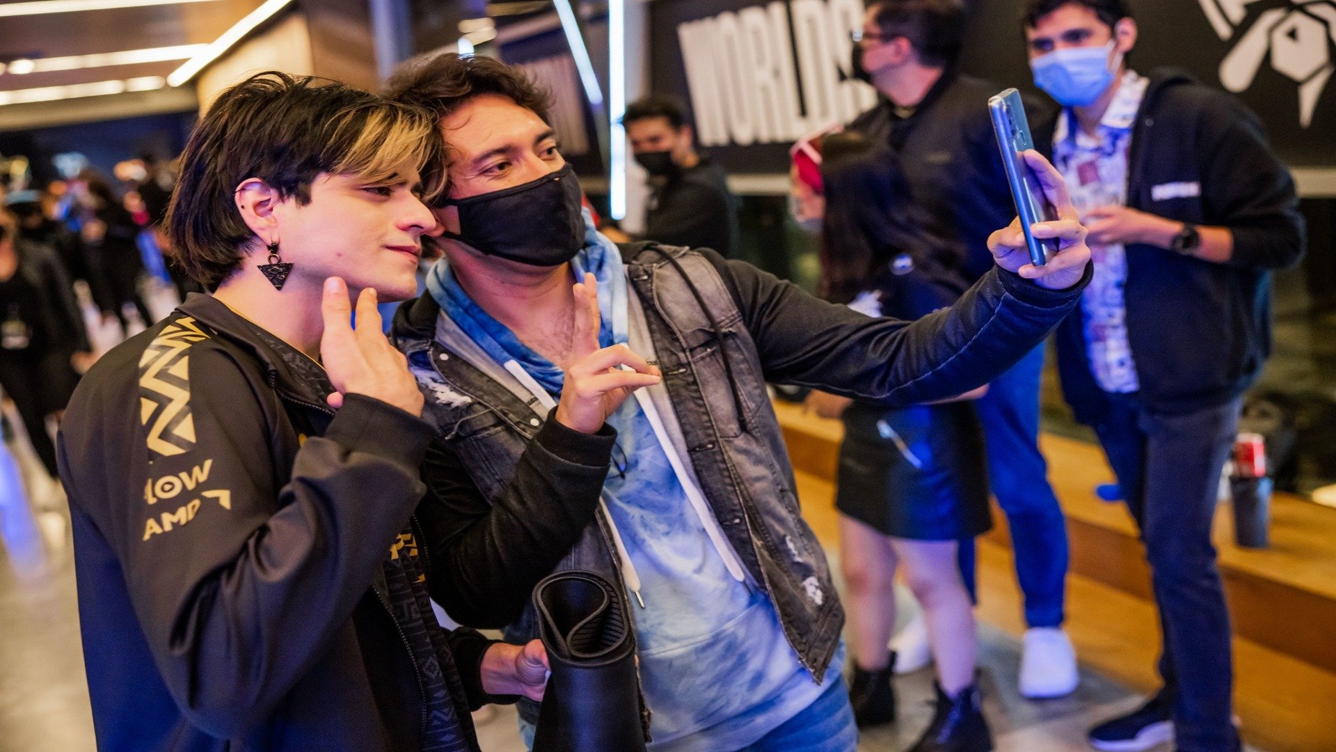 Isurus's owner take a photo with fans during the 2022 Worlds play-ins day three