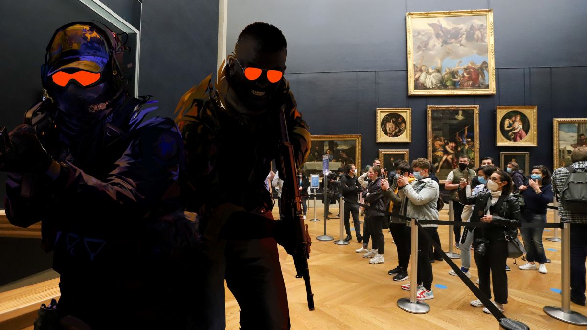 People look at Counter-Strike art in the Louvre.