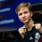 A portrait of m0NESY in his G2 Esports jersey, holding the CS2 10-Year Veteran Coin.