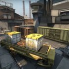 The A bombsite on Train in CS:GO with an assortment of train carriages in a yard.