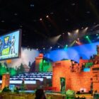 An esports arena with large TV screens and a stage